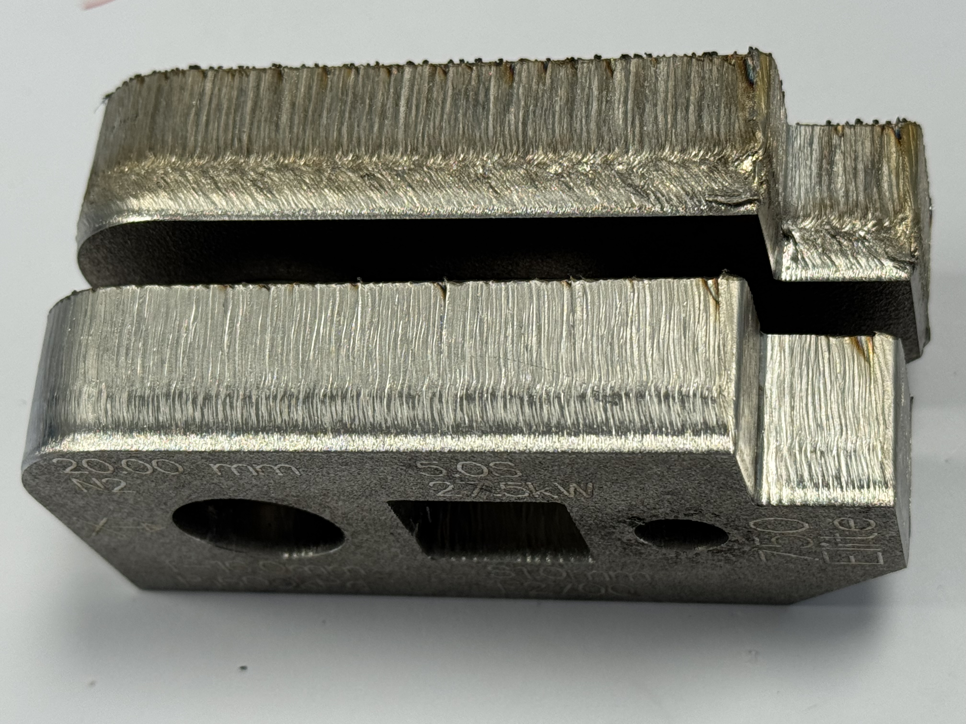 Upper part cut with standard pierce, develops rough bead around midline, below which striations are more irregular and cut has more dross. Edge starting avoided this, as did use of the laser loop lead extension after piercing, as in the lower part (20mm SS cut with N2) Upper part cut with standard pierce, develops rough bead around midline, below which striations are more irregular and cut has more dross. Edge starting avoided this, as did use of the laser loop lead extension after piercing, as in the lower part (20mm SS cut with N2)